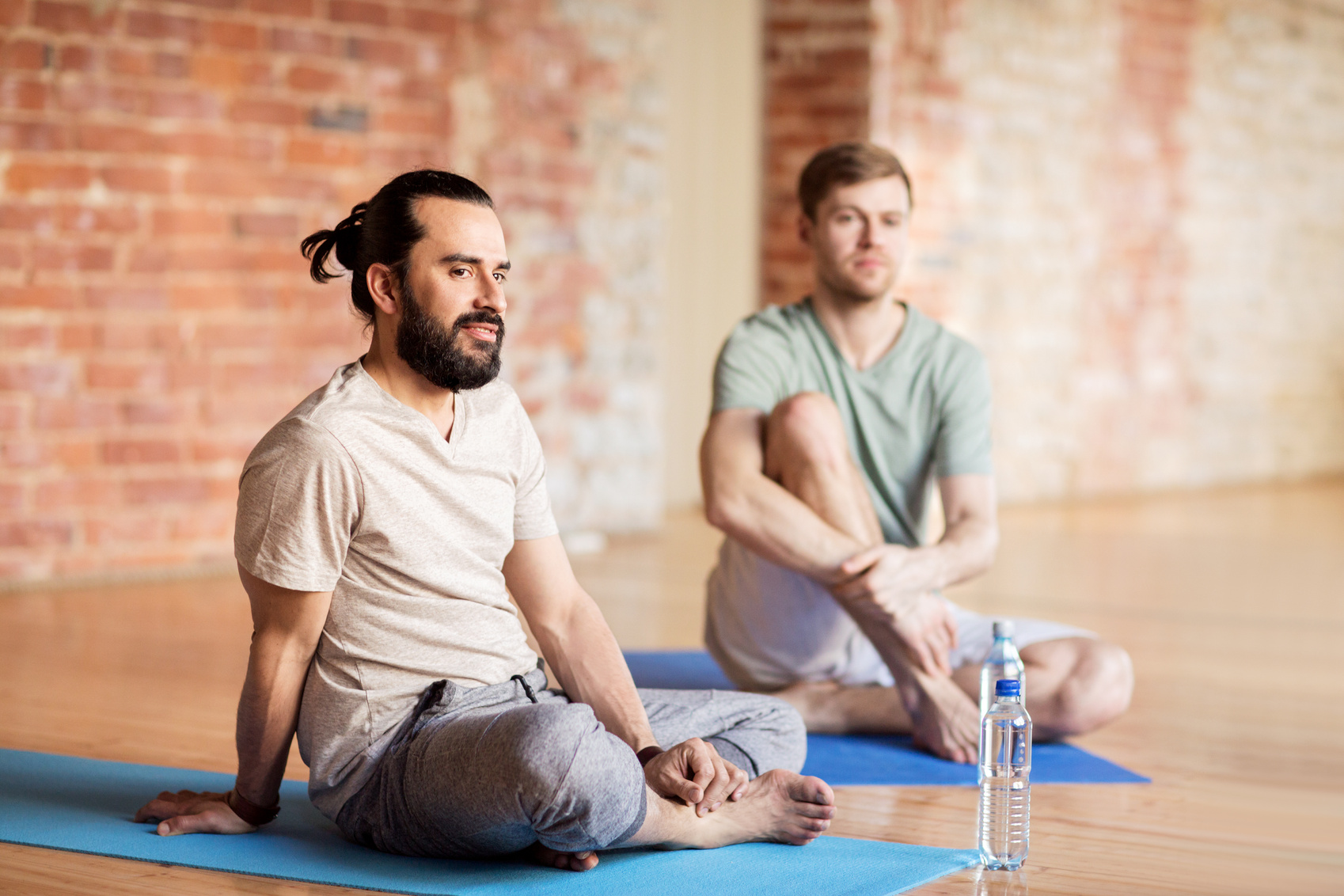 Men Resting on Mats at Yoga Studio